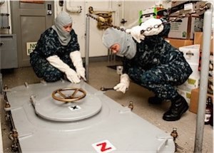 120906-N-HV737-001 PACIFIC OCEAN (Sept. 6, 2012) Logistics Specialist Seaman Apprentice Kaityln Walker, left, and Logistics Specialist Seaman Jeanne Paulaski dog down a water tight hatch aboard the Nimitz-class aircraft carrier USS John C. Stennis (CVN 74) during a general quarters drill. John C. Stennis is returning to the U.S. 5th and 7th Fleet areas of responsibility four months ahead of schedule in order to maintain combatant commander requirements for presence in the region. (U.S. Navy photo by Mass Communication Specialist 2nd Class Charlotte C. Oliver/Released)